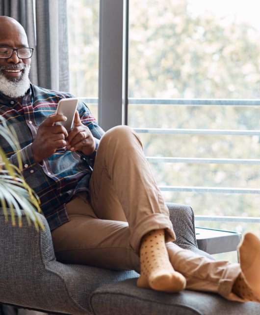 older man looking at phone